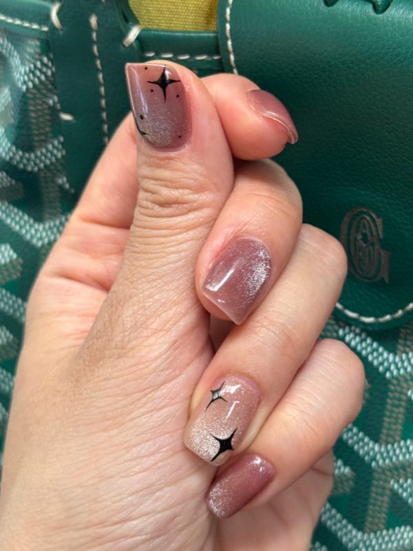 Shimmer nails with black star nail-art details