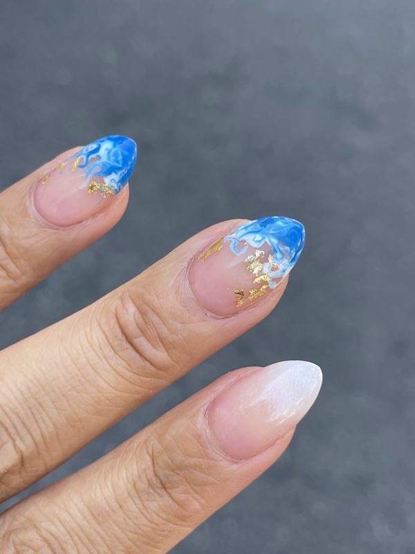 Blue ombre almond nails with gold foil accents